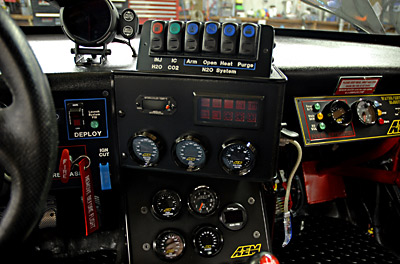 Upper center showing DEFI tachometer, top gases switches (CO2 and H2O injection) N20 (nitrous oxide) controls. Left area is parachute launch controls, air system launch indicators and the Halon Fire release system.